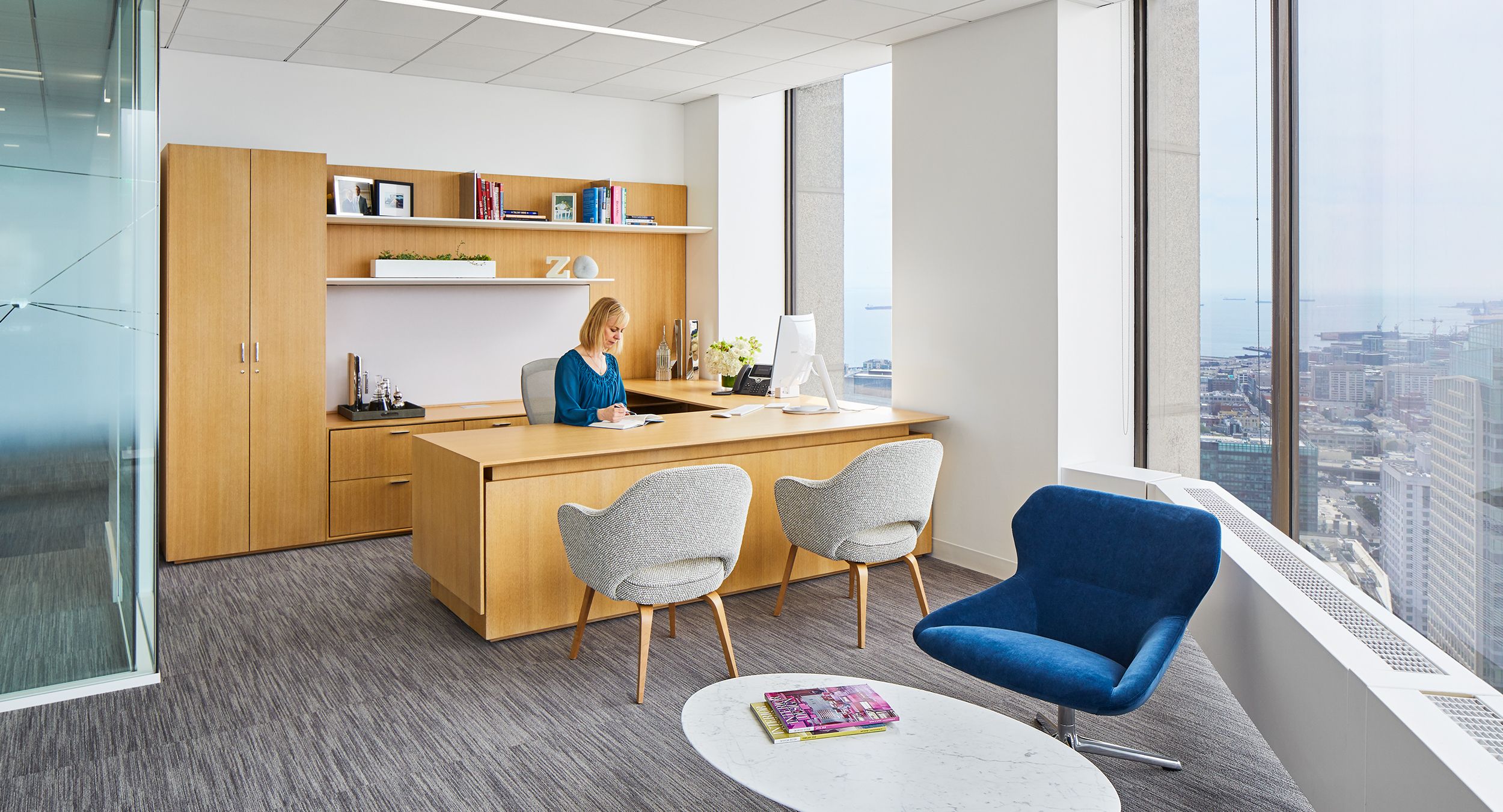 Beautiful private offices feature custom-designed adjustable-height desking in Rift White Oak.