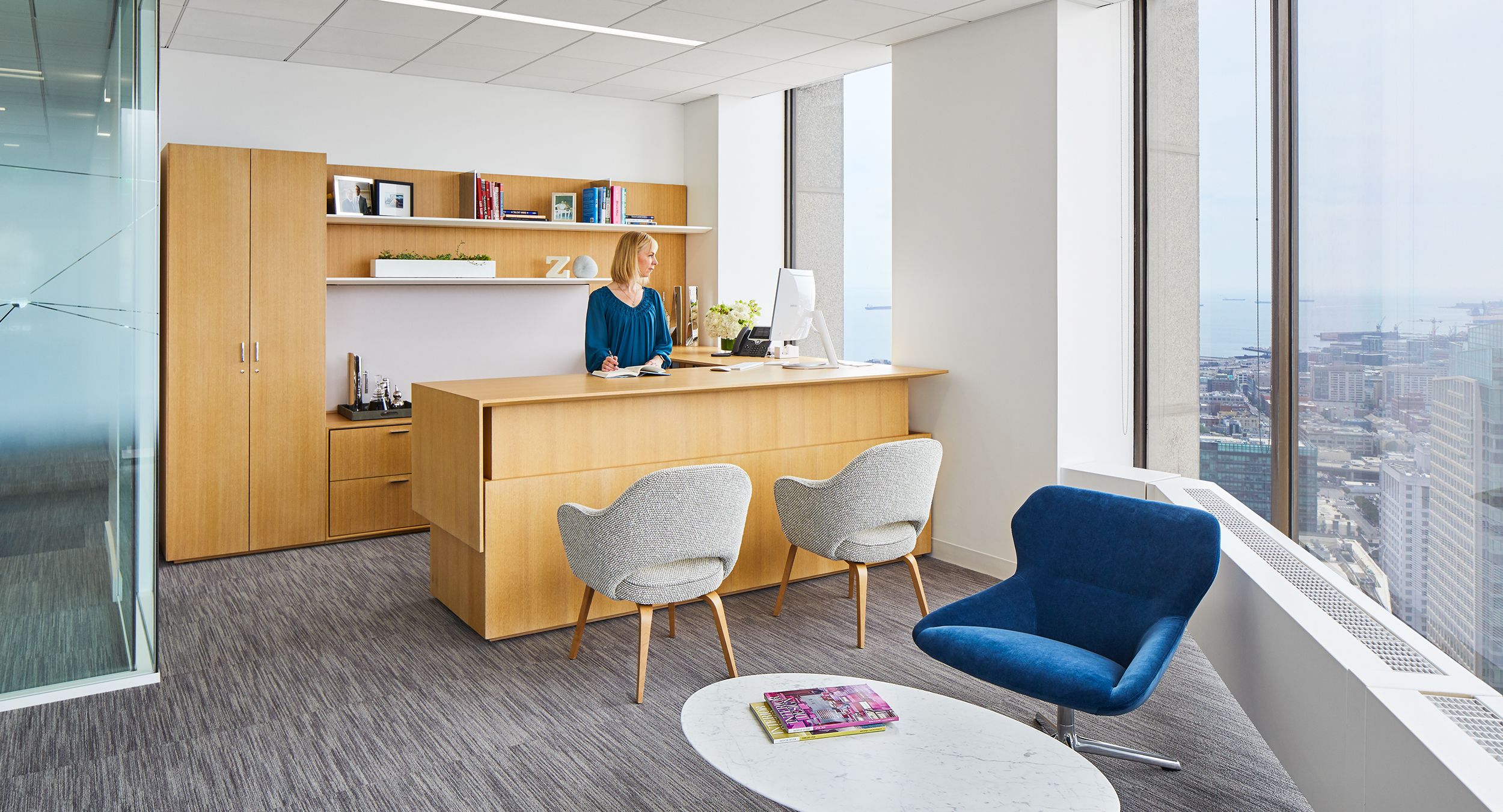 Beautiful private offices feature custom-designed adjustable-height desking in Rift White Oak.