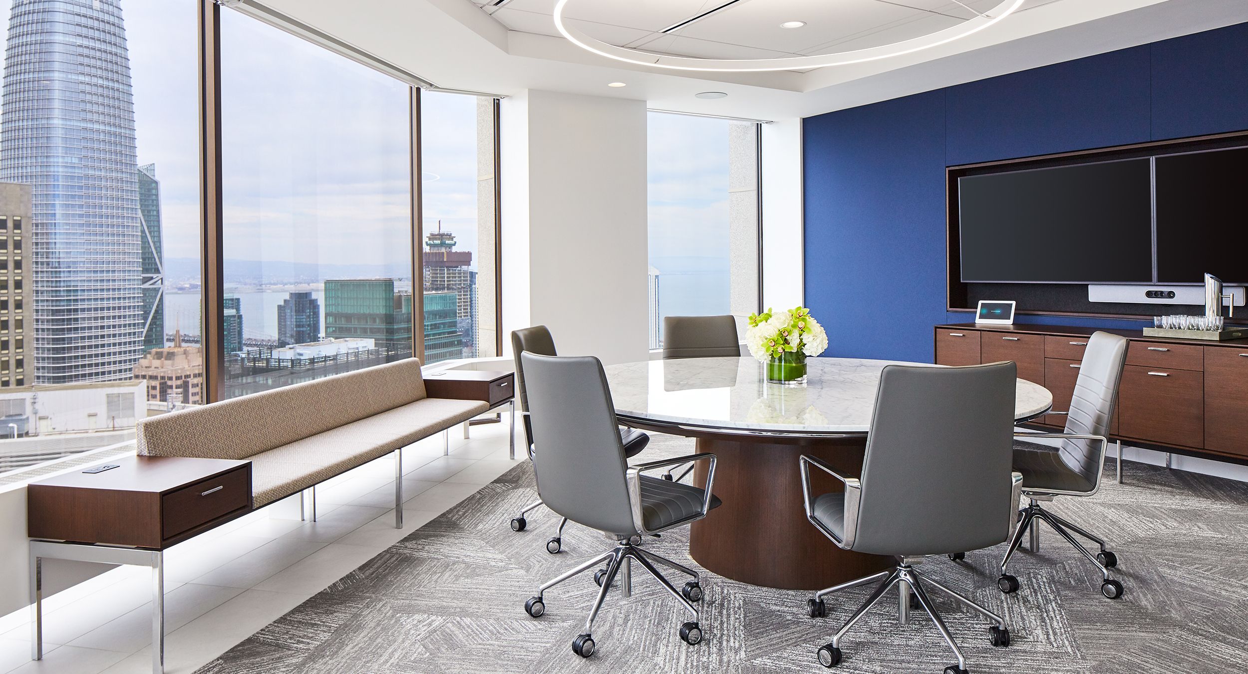 HALO storage and gallery seating complement a stunning MESA table in stone and chrome.