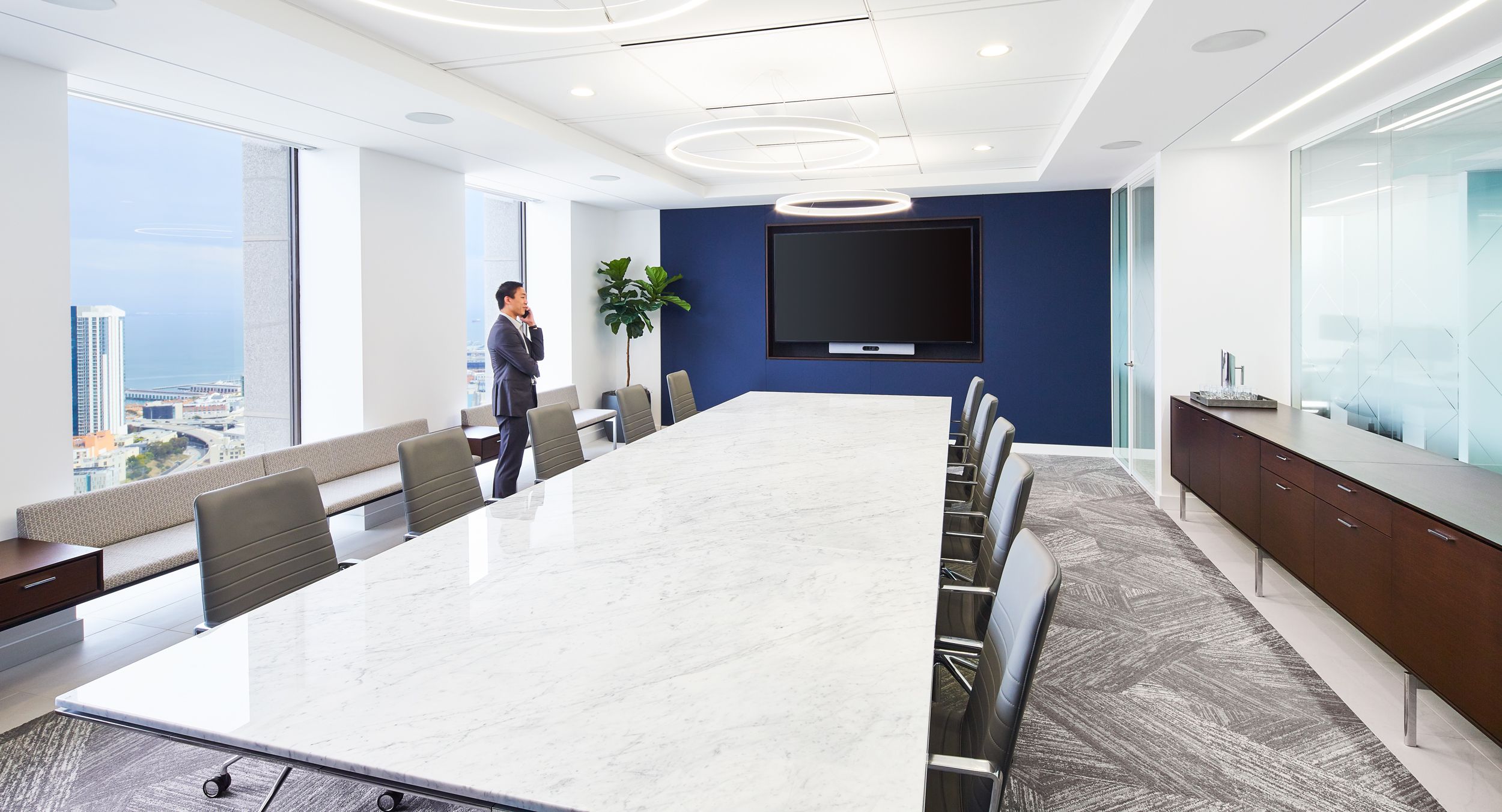 HALO storage and gallery seating complement a stunning MESA table in stone and chrome.