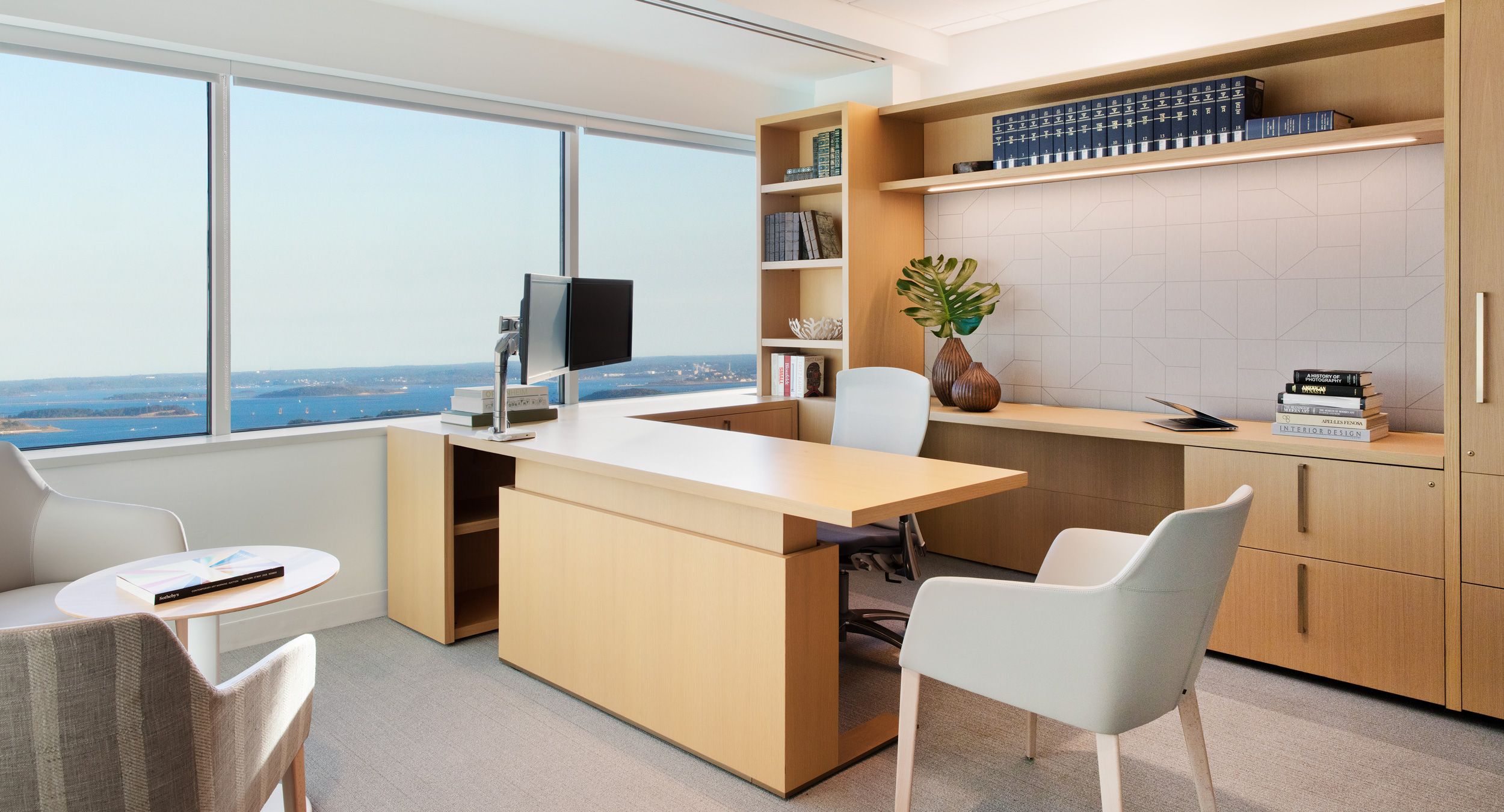 Custom adjustable-height NEW MILLENNIA private office in custom oak  finish with satin brass hardware.