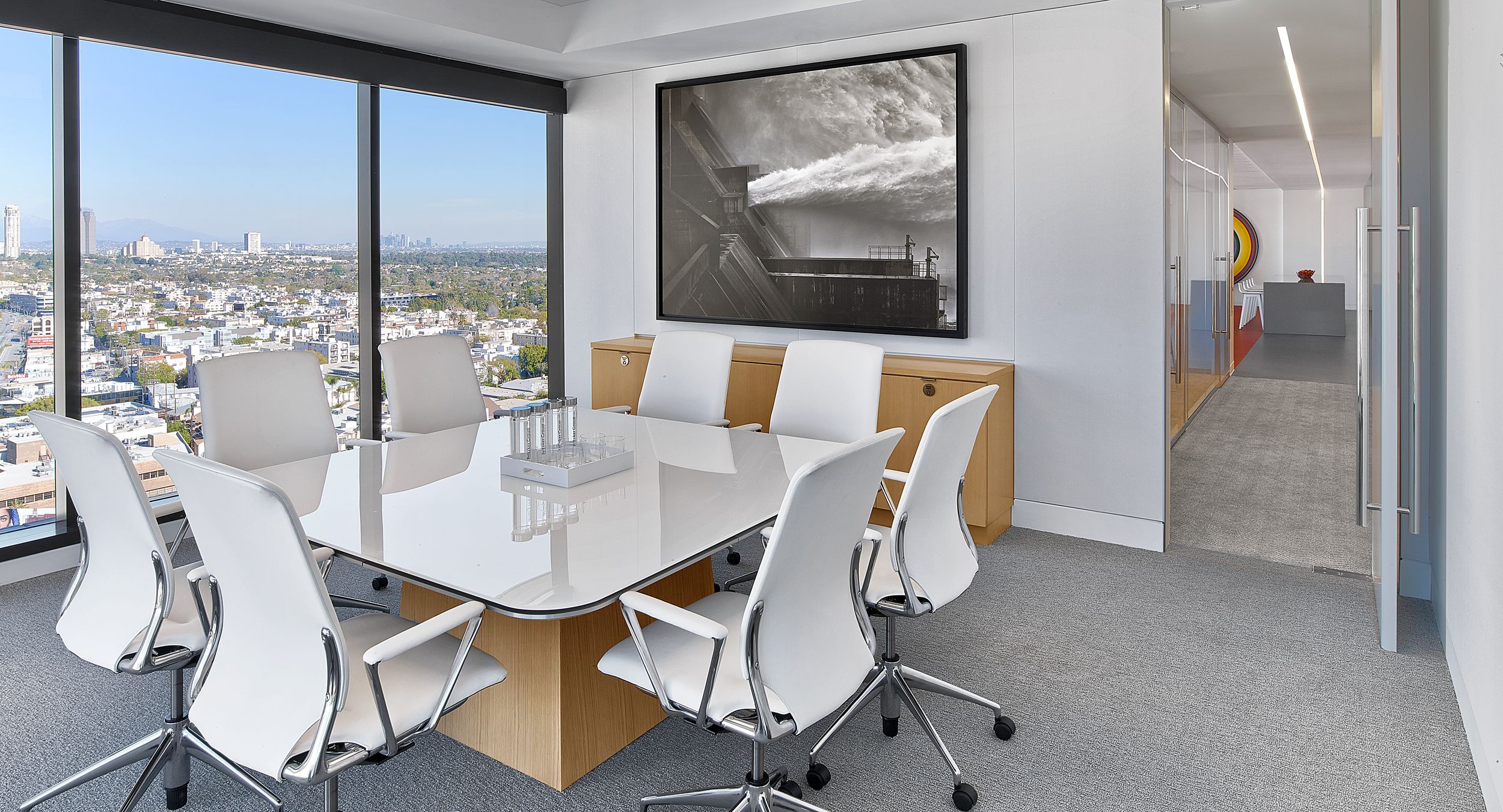Each MESA table is specified with an Alpine White glass surface, brushed satin aluminum edge, and rift white oak base.