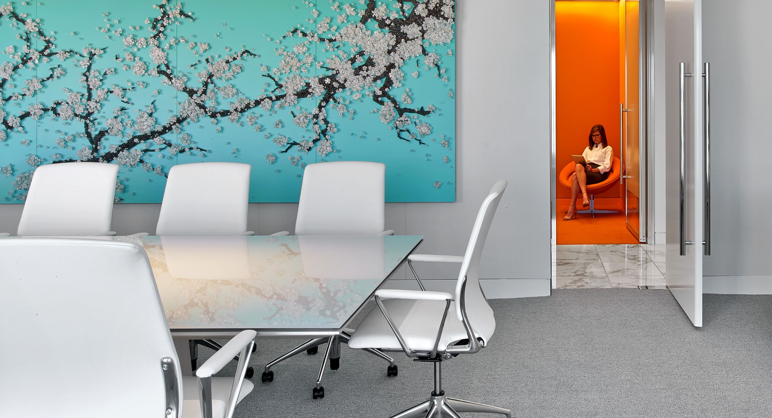 Glass MESA tables provide a beautiful, clean meeting surface for this colorful office.