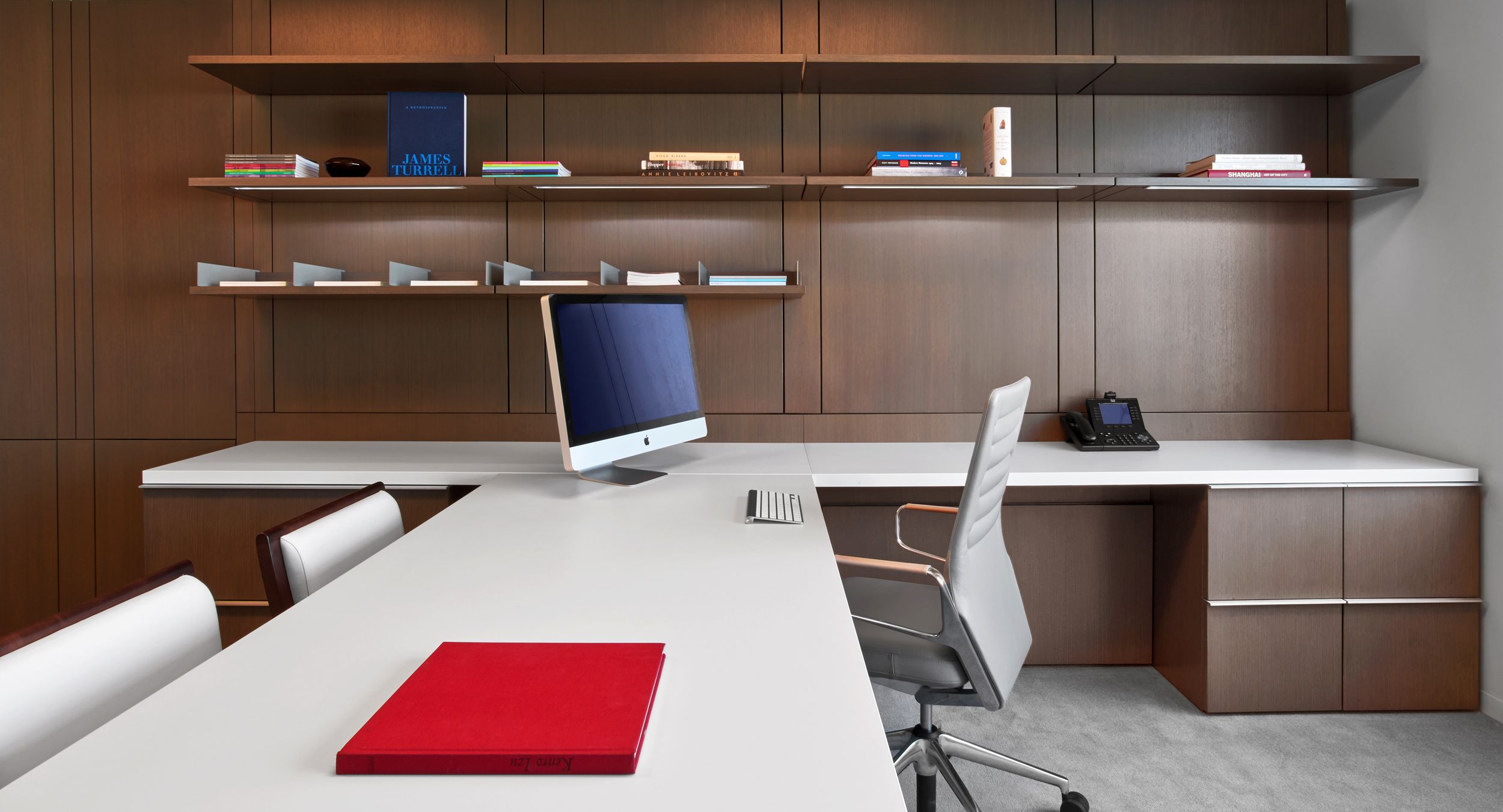 Private offices feature rift oak workwalls, Smoky White laminate surfaces, and brushed aluminum hardware.