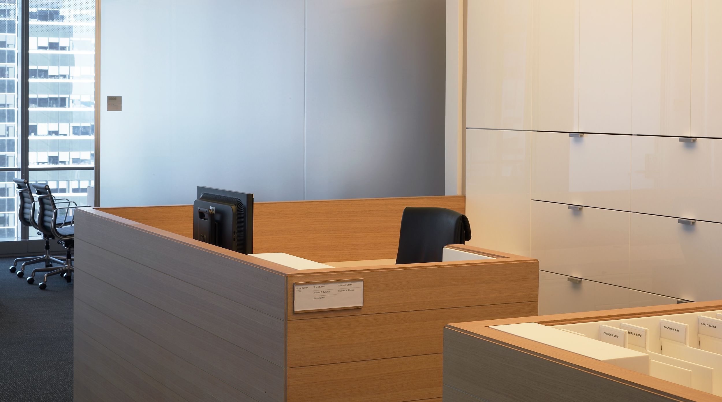 Custom secretarial stations feature Cerused Oak surrounds and high gloss white Parapan file fronts.