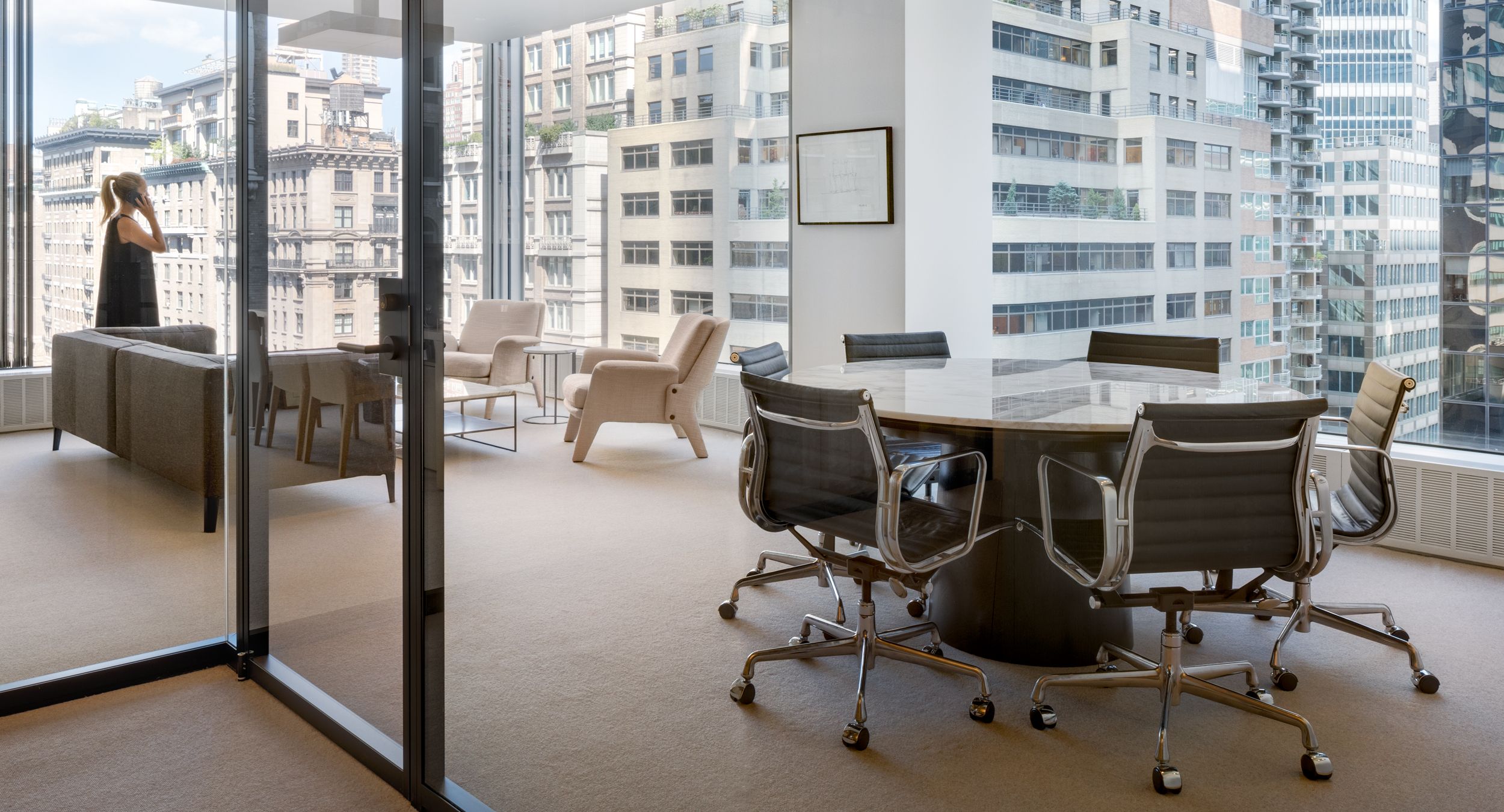 An executive suite features a round MESA table with beautiful stone surface.