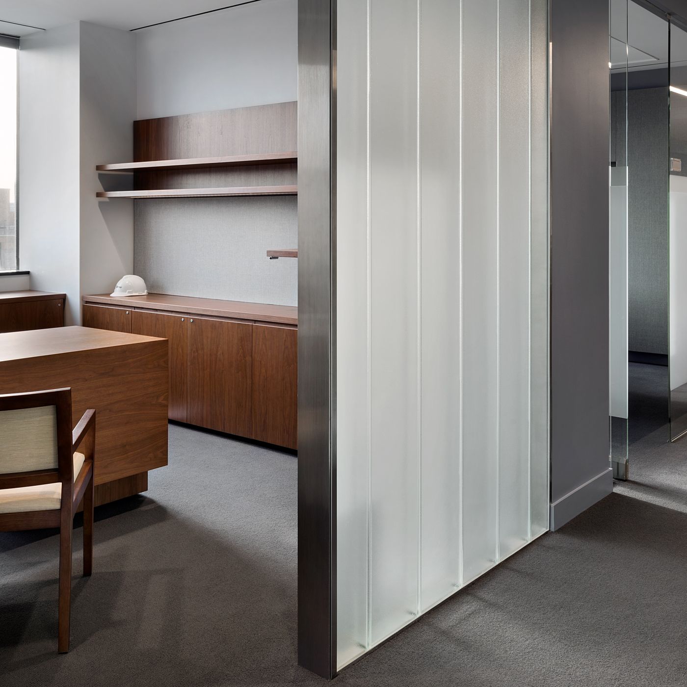 NEW MILLENNIA private offices include adjustable-height desking and continuous floating shelves.