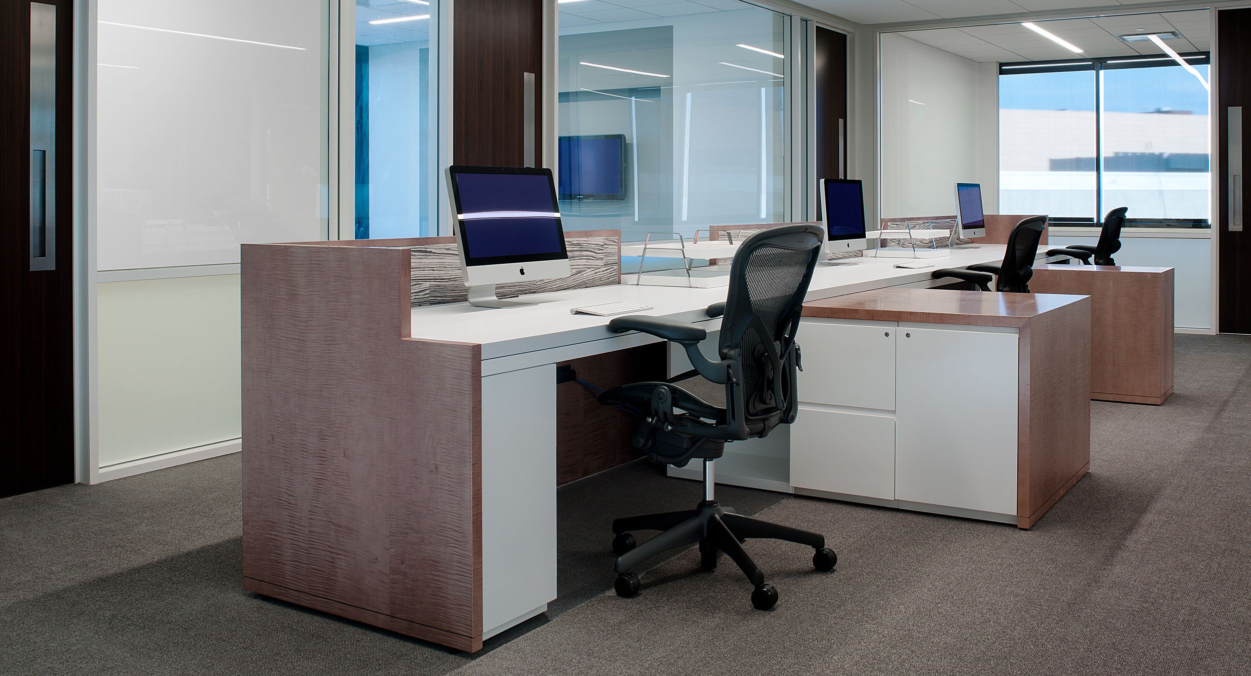 NEW MILLENNIA casework in white Chemcolor contrasts beautifully with Figured Sycamore veneers.